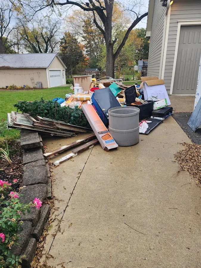 Dumpster being loaded with debris for 12 Yard Dumpster Rental in Hillsborough